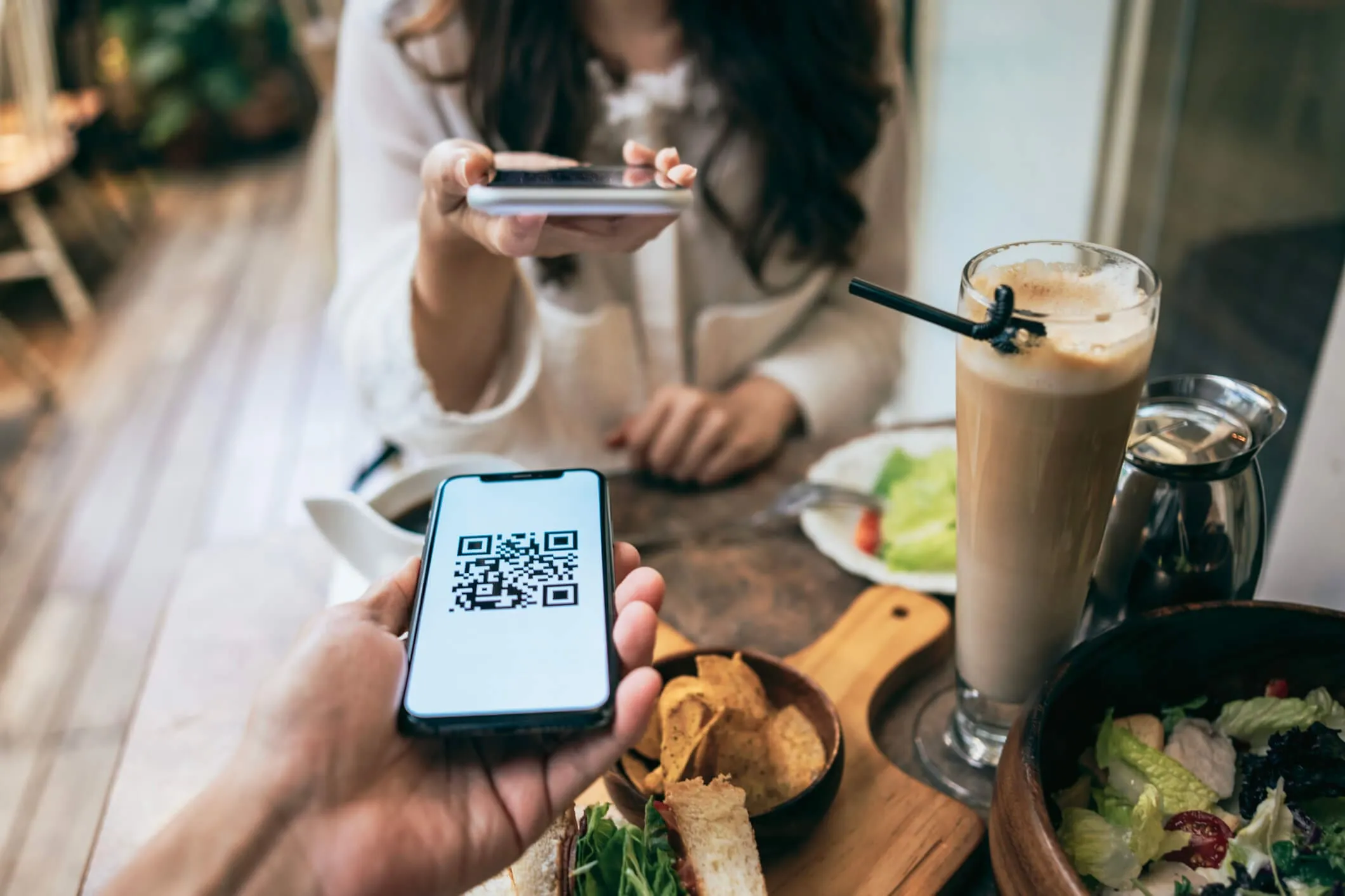 Diner scanning a QR code at the table to order and pay