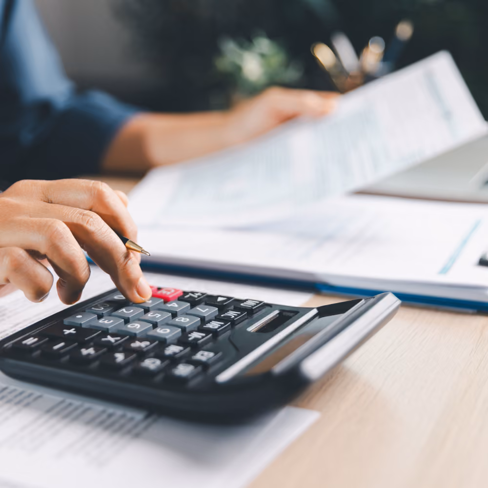 Office desk close-up. Person working on tax return.