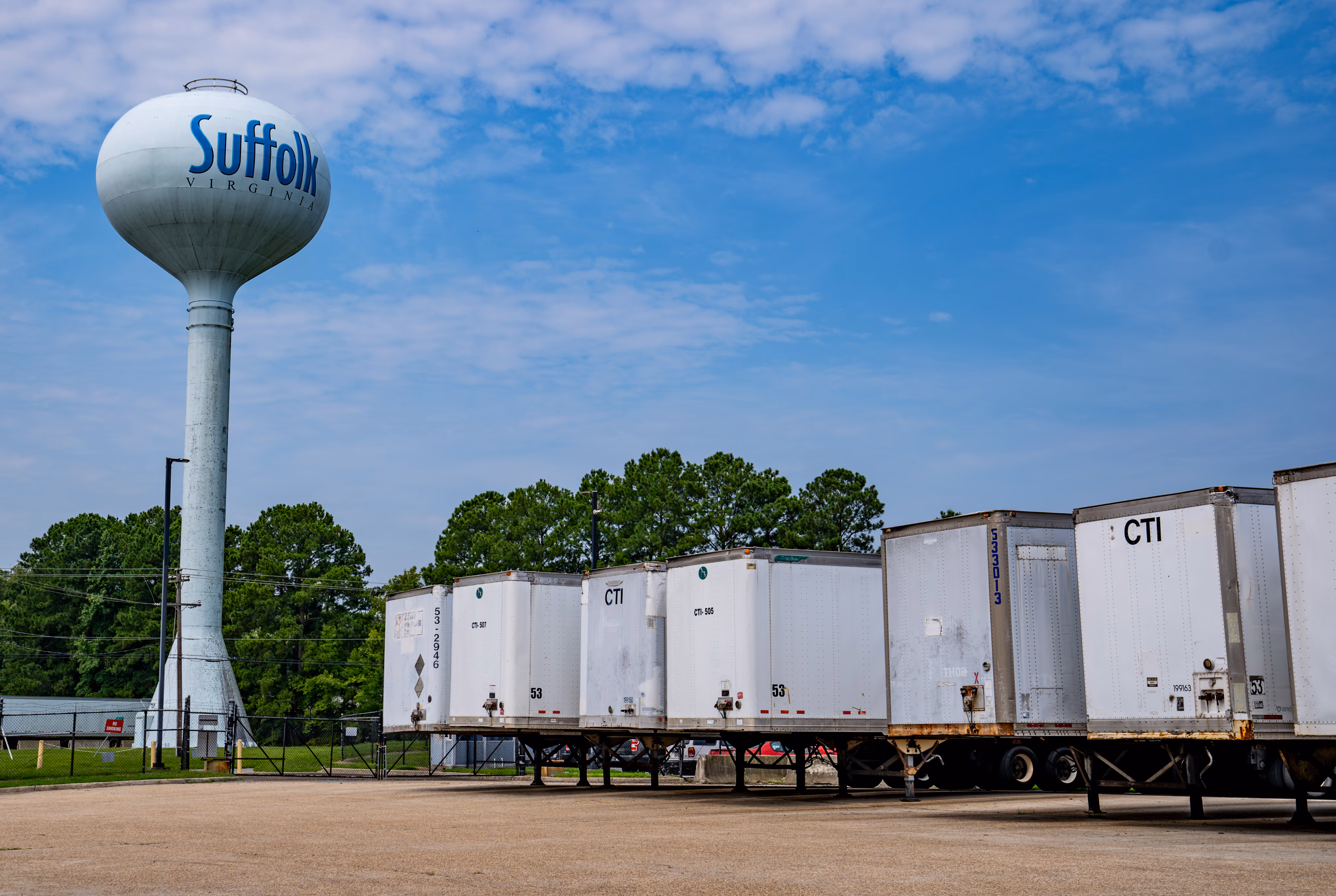 Distribution trailers parked beneath the Suffolk water tower