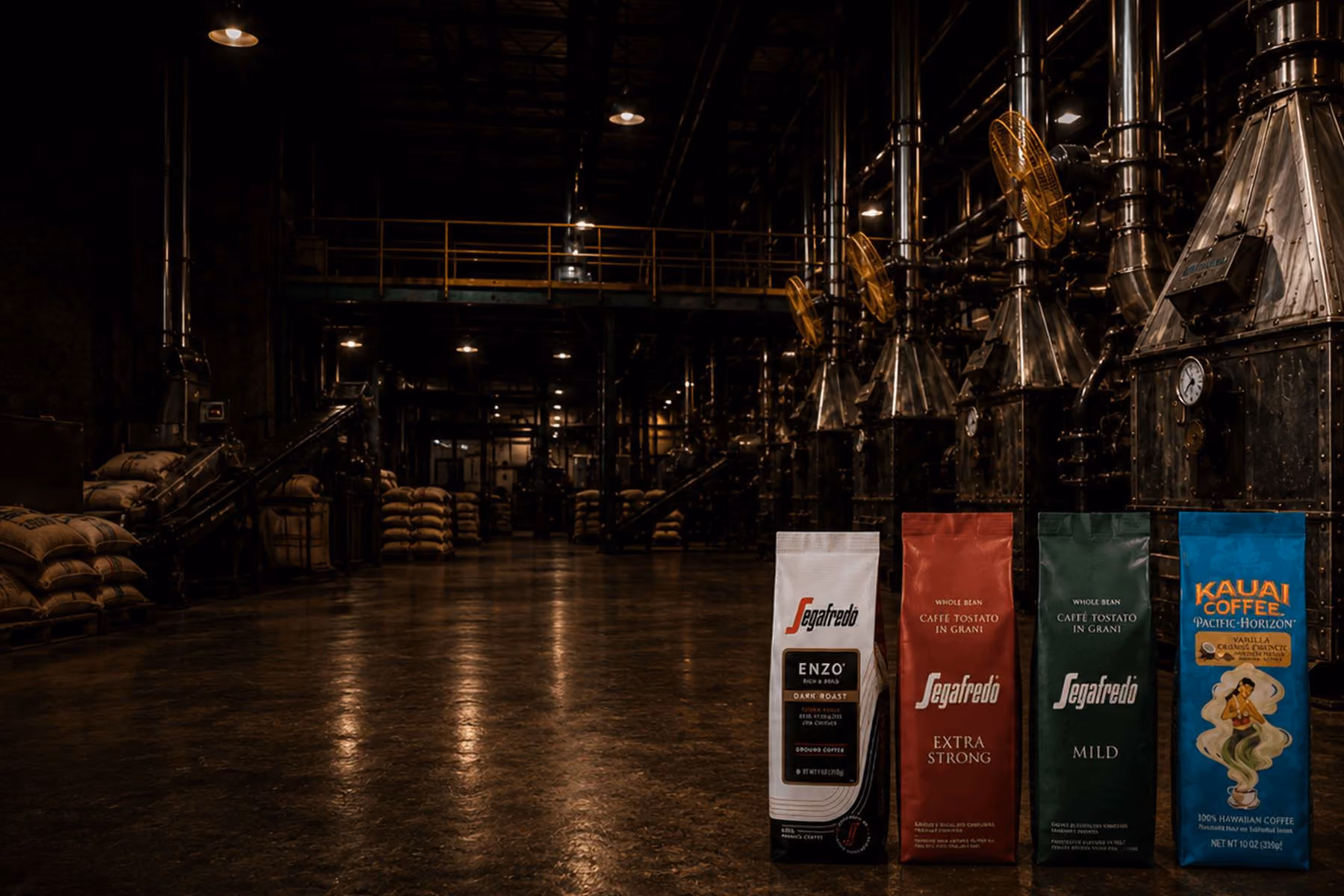 Segafredo and Kauai Coffee retail bags lined up on the floor of an MZB roasting plant