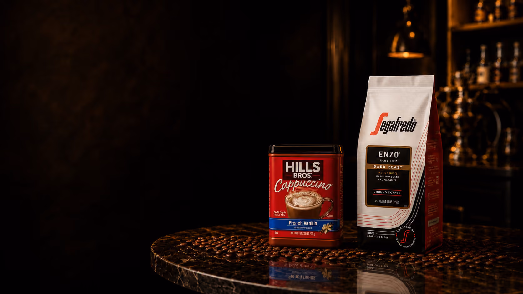 Hills Bros. Cappuccino and Segafredo packaging staged on a dark table