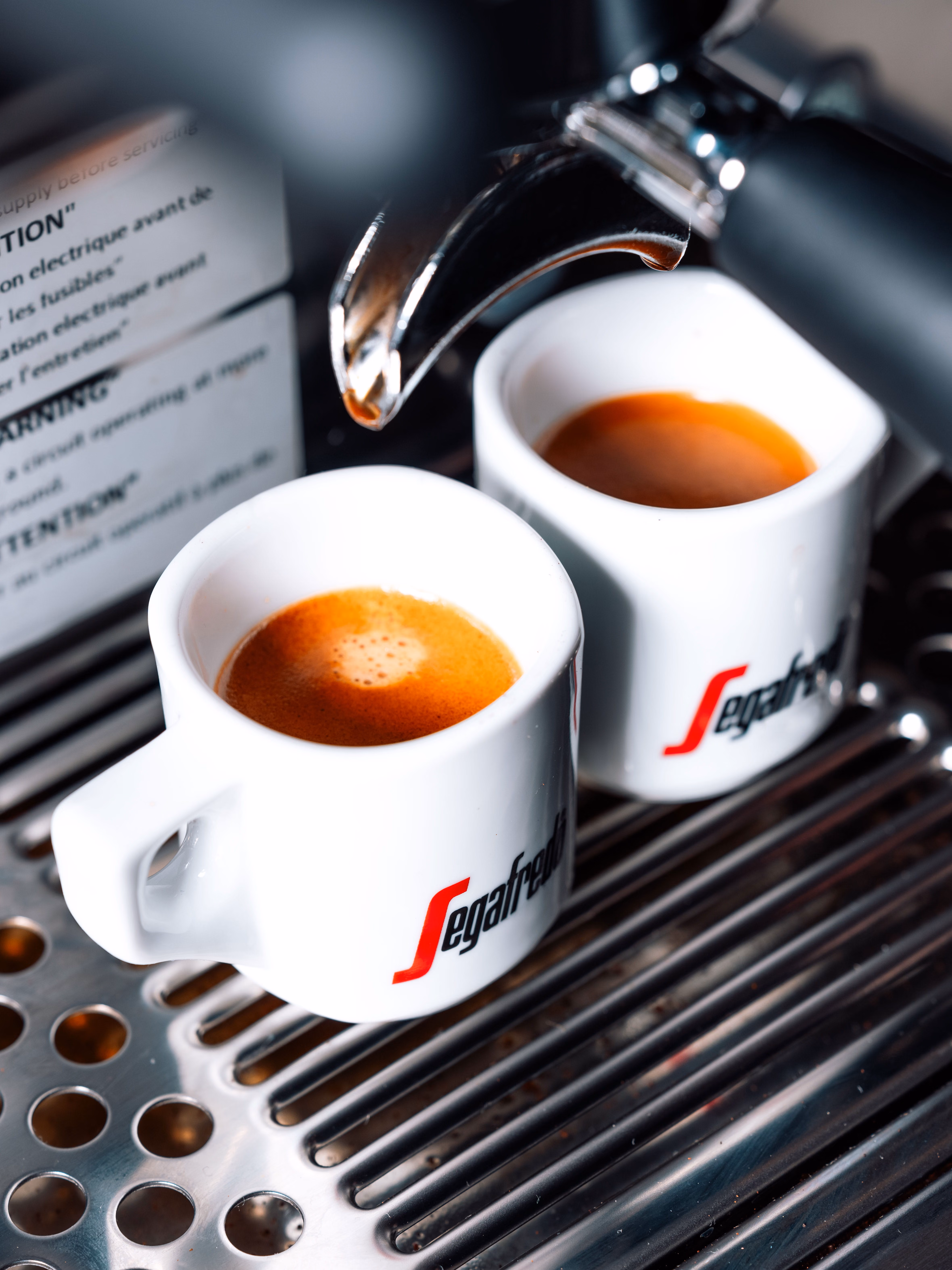 A chrome Segafredo espresso machine pulling two shots