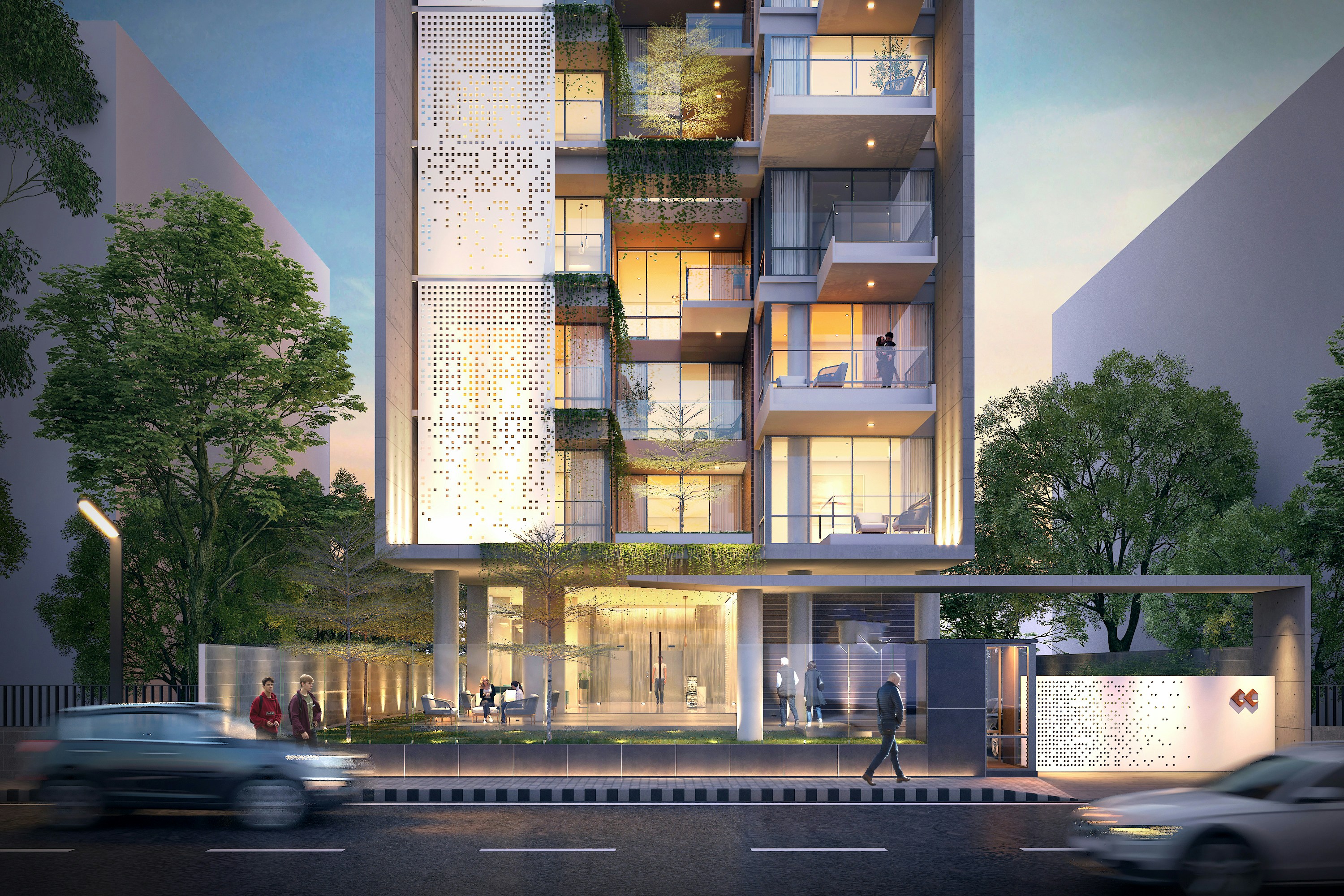 Modern apartment community with illuminated residences and landscaped greenery at dusk