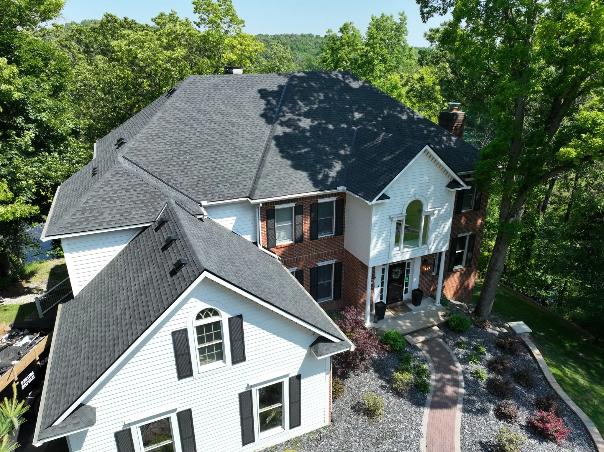 Completed black asphalt shingle roof installed by Armor Roofing