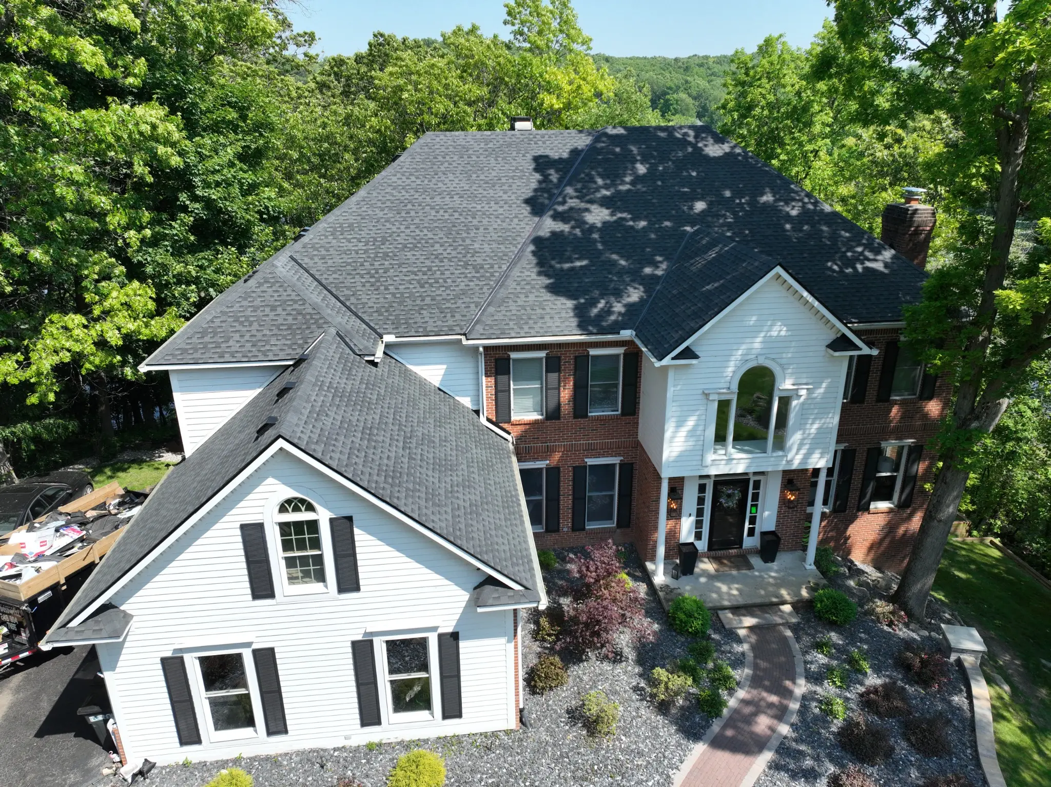 Completed black asphalt shingle roofing system installed by Armor Roofing