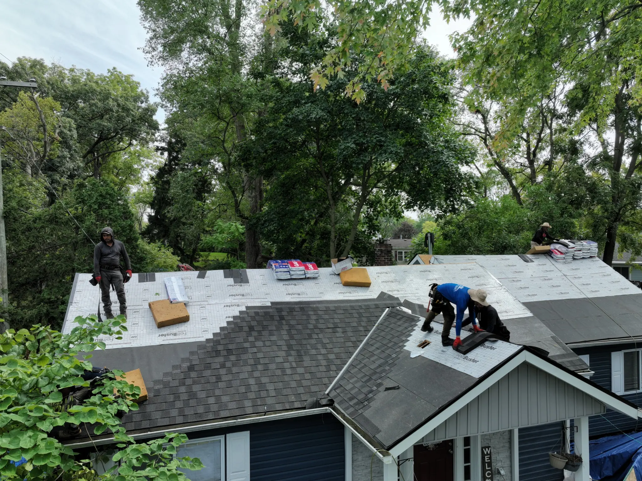 Armor Roofing crew installing deck protection and asphalt shingles as part of a complete roofing system