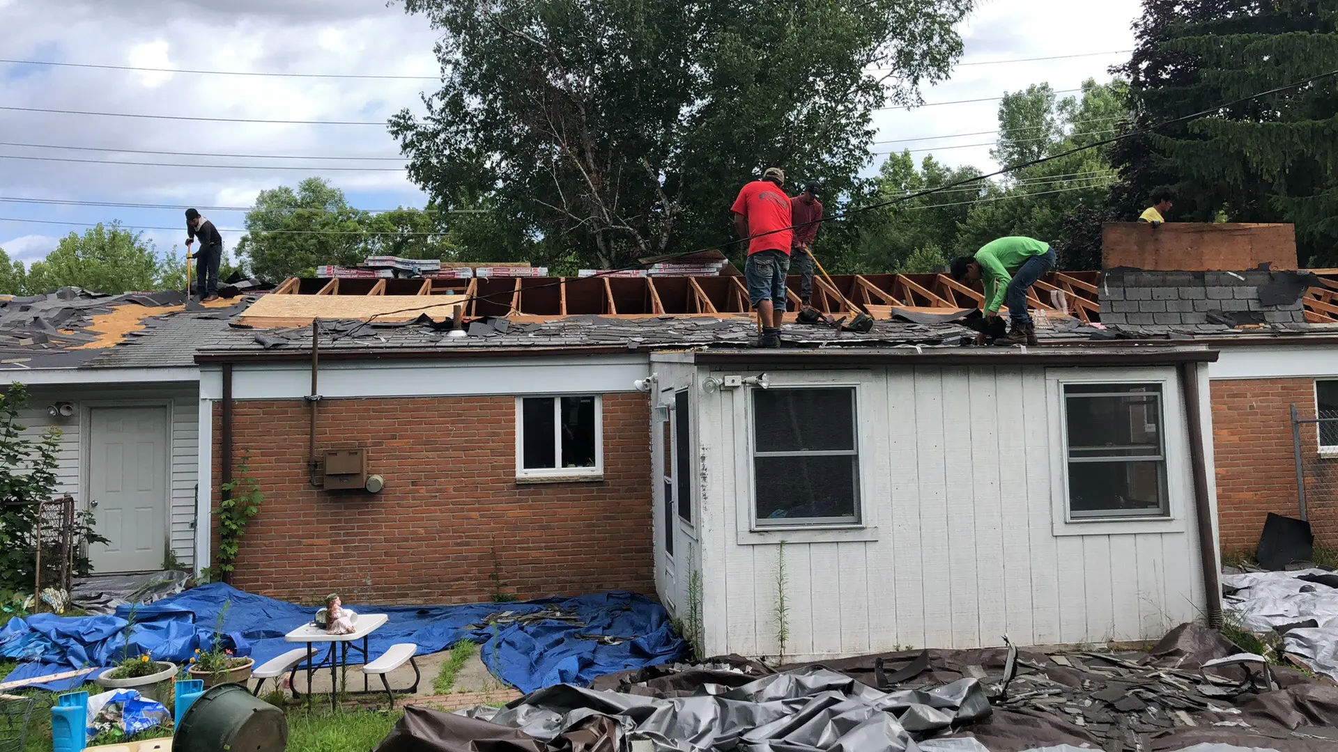 Roof tear-off exposing the existing deck and framing during an Armor Roofing project