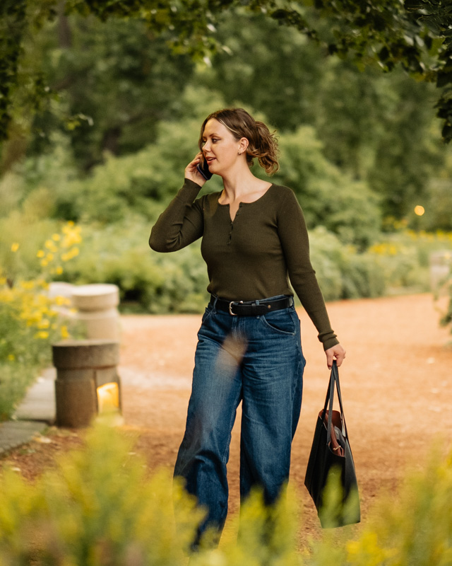 Ellen Bestland walking along a park path while talking on the phone
