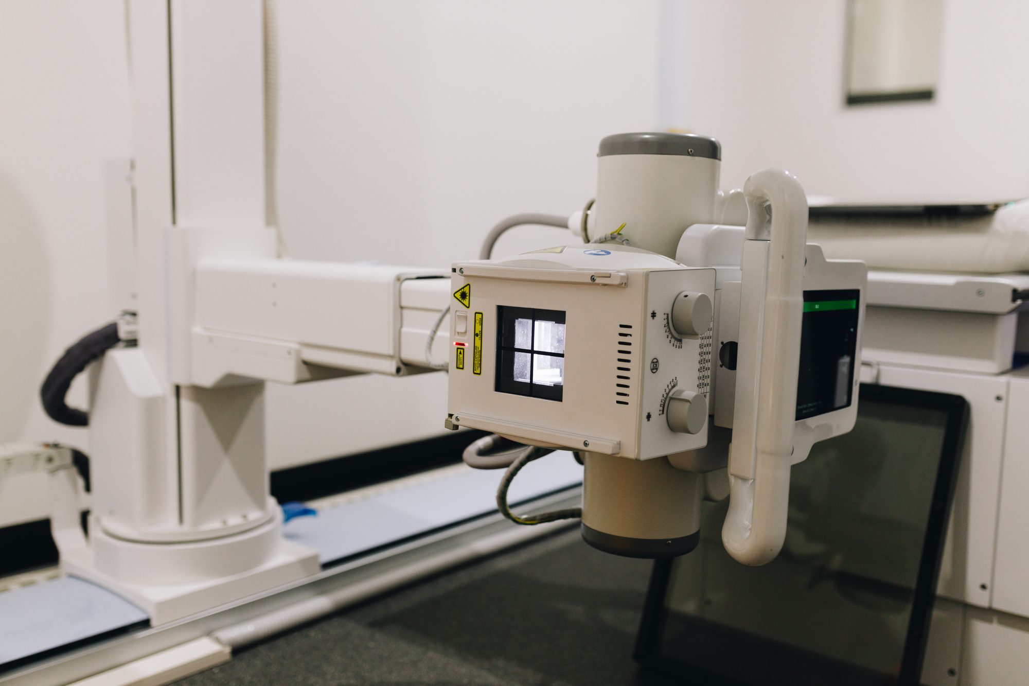 Digital X-ray tube head and detector positioned for a musculoskeletal examination