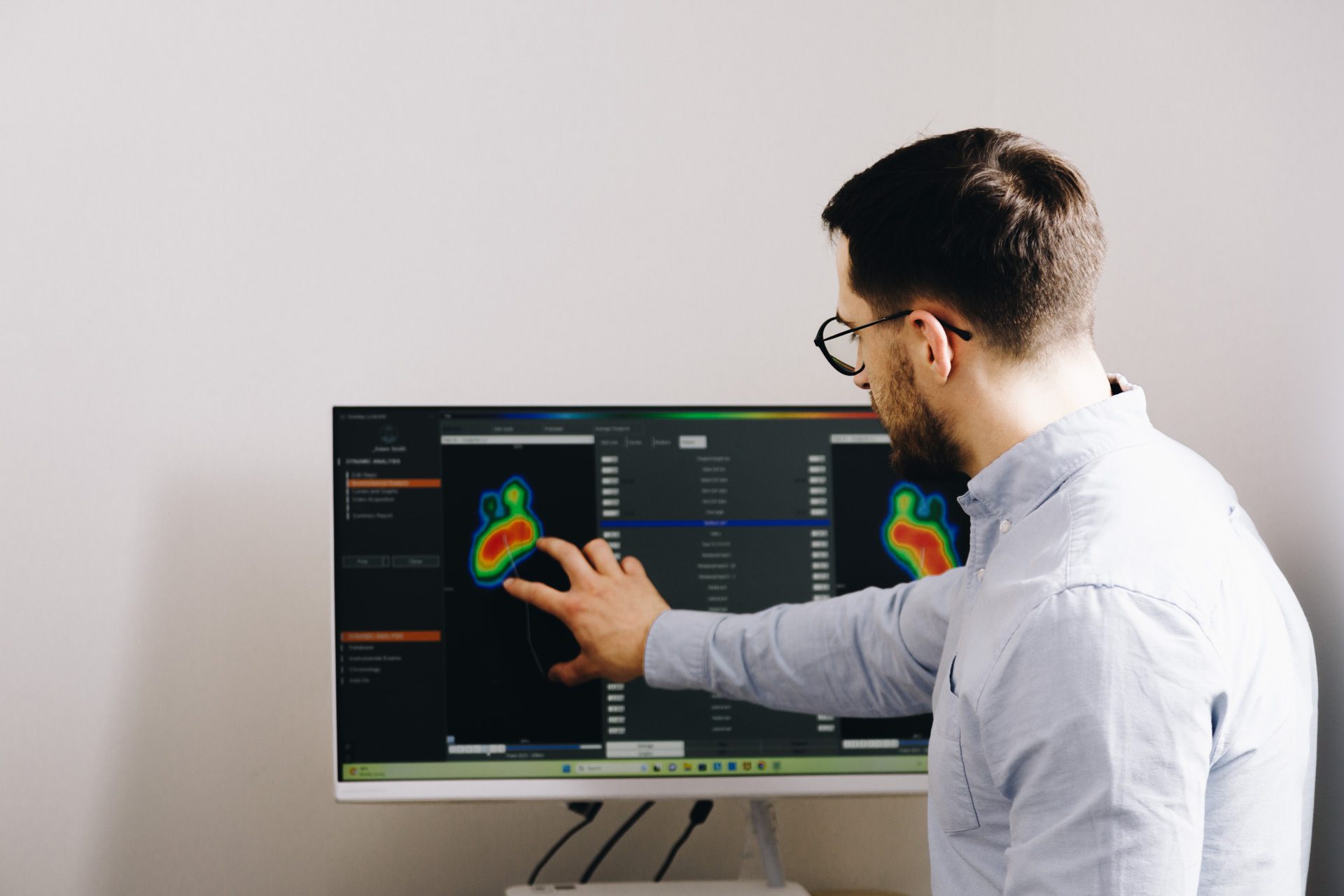 Podiatrist reviewing dynamic foot pressure mapping on screen
