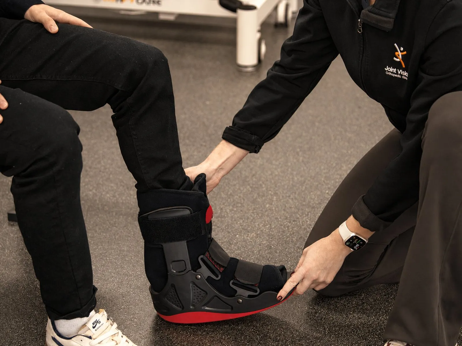 Clinician fitting a walking boot during a fracture and injury consultation at Joint Vision Orthopaedic Group