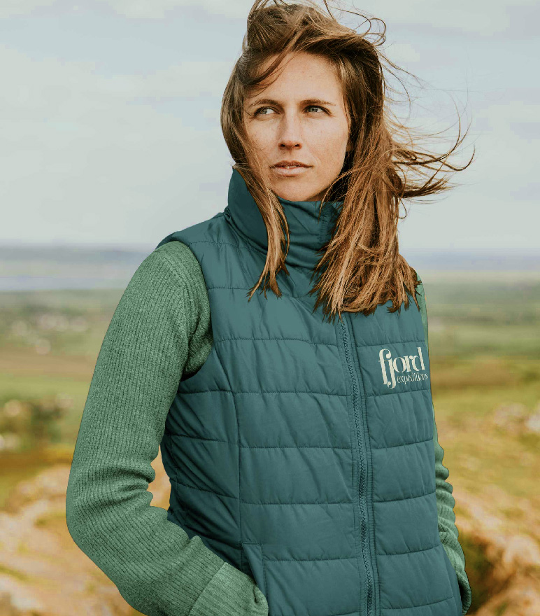 Fjord Expeditions branded puffer vest with the compass and rune mark