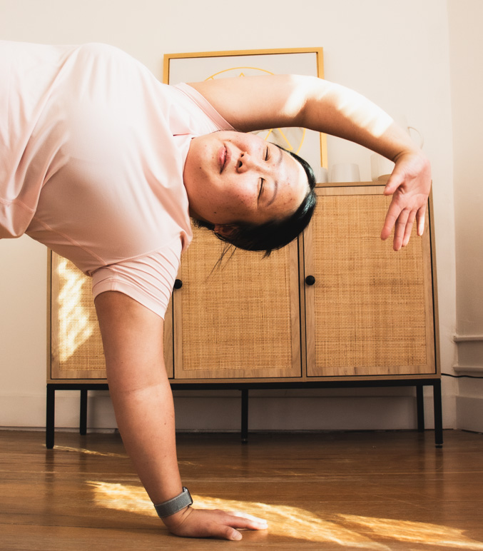 A client holding a side plank during mobility training at Encompass Movement, Winnipeg
