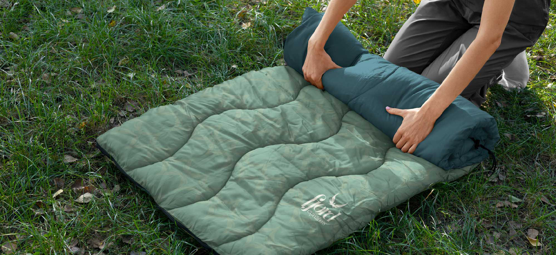 Fjord Expeditions branded camping blanket laid out at a campsite