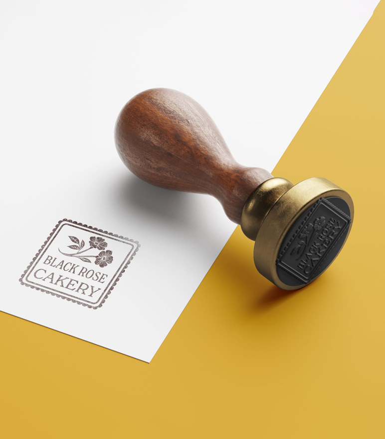 Wooden stamp of the Black Rose Cakery logo