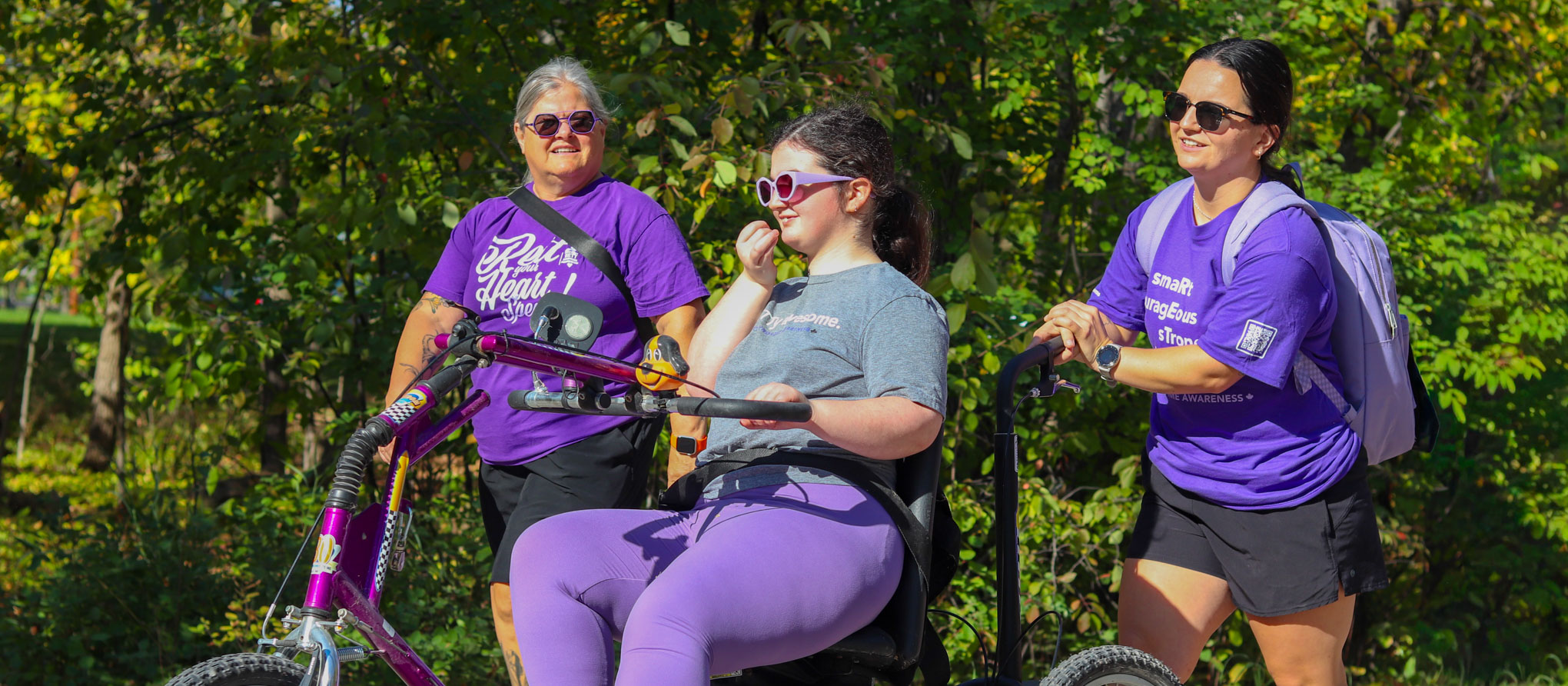A girl riding an adaptive trike at a Rett syndrome awareness event in Winnipeg