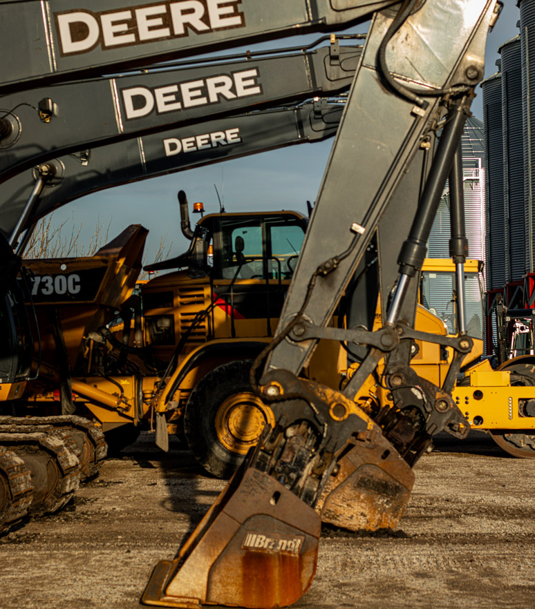 A fleet of John Deere excavators lined up in the Bestland Excavation yard