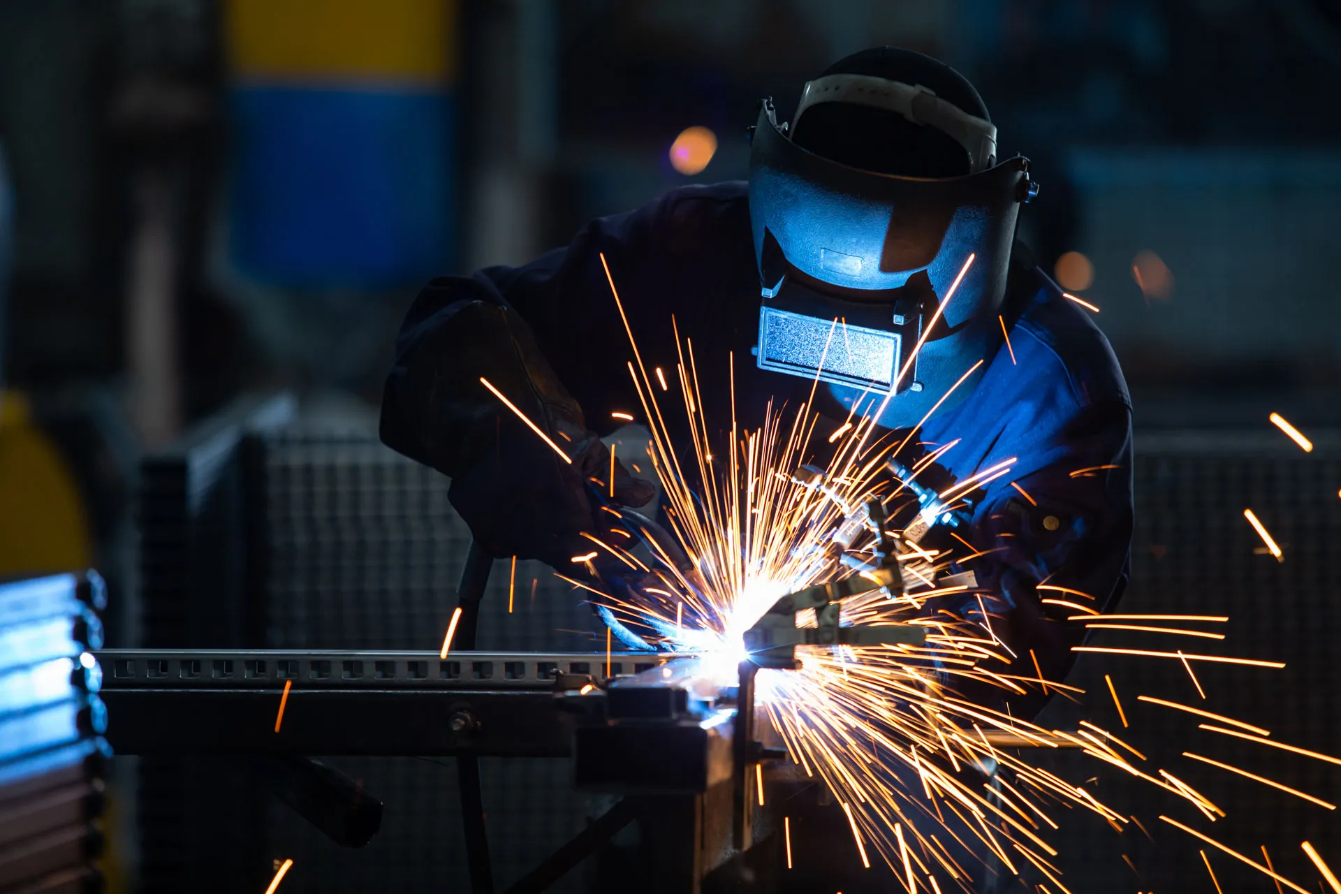 Welder working on a fabricated steel assembly