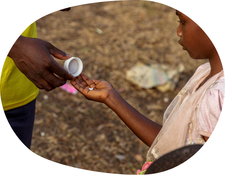 One man giving pills to another man who is the holding pills in his right hand.