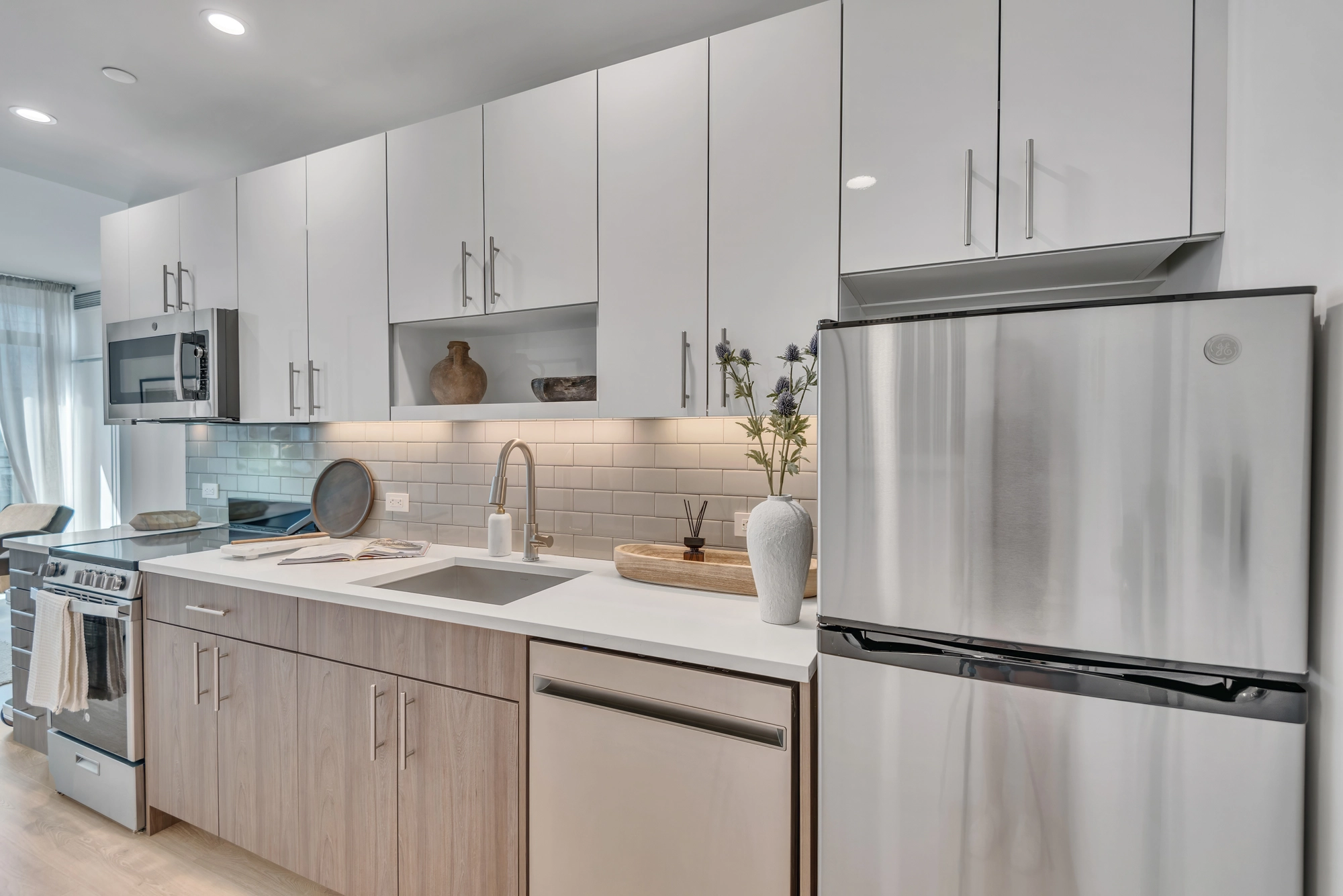 Maxwell apartment kitchen with island and stainless steel appliances