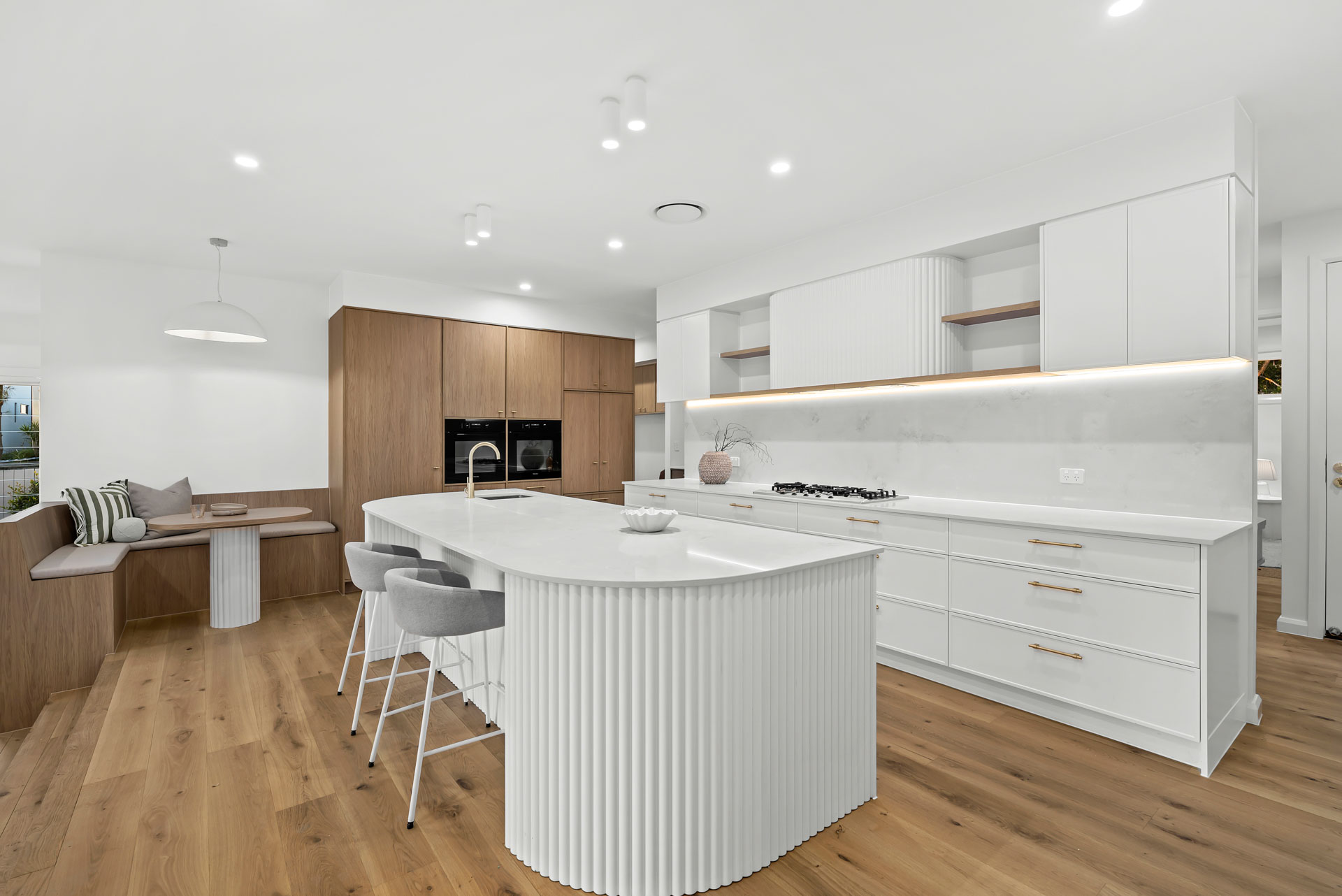 Kitchen with fluted island bench and banquette dining