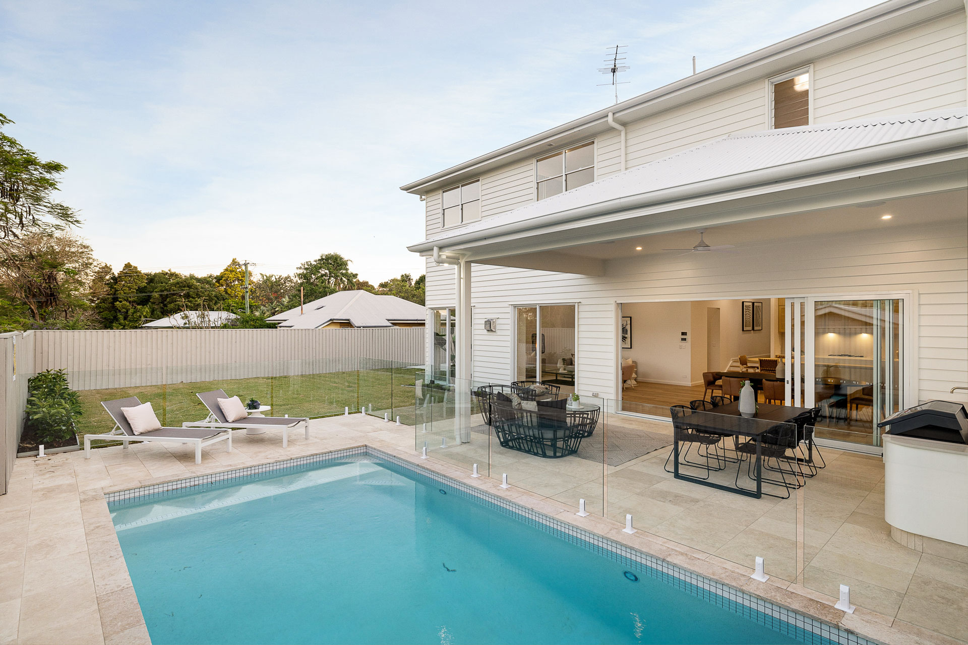 Pool, covered outdoor living and lawn