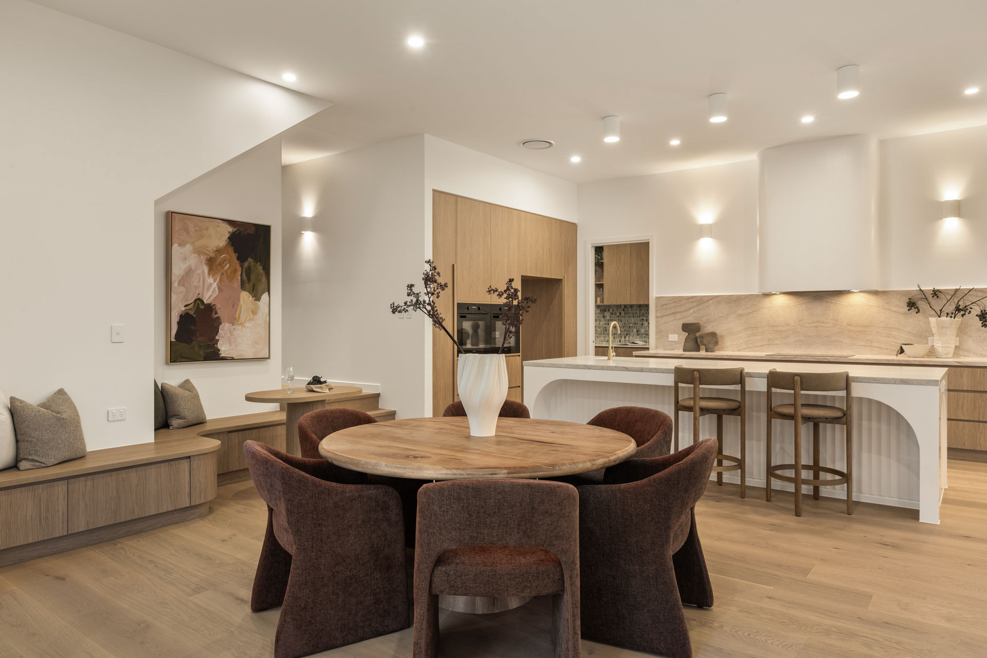 Dining area, banquette seating and kitchen beyond