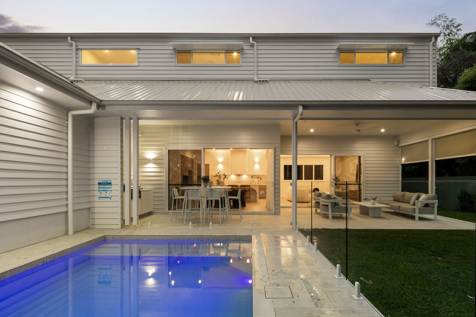 Pool and covered outdoor living at dusk