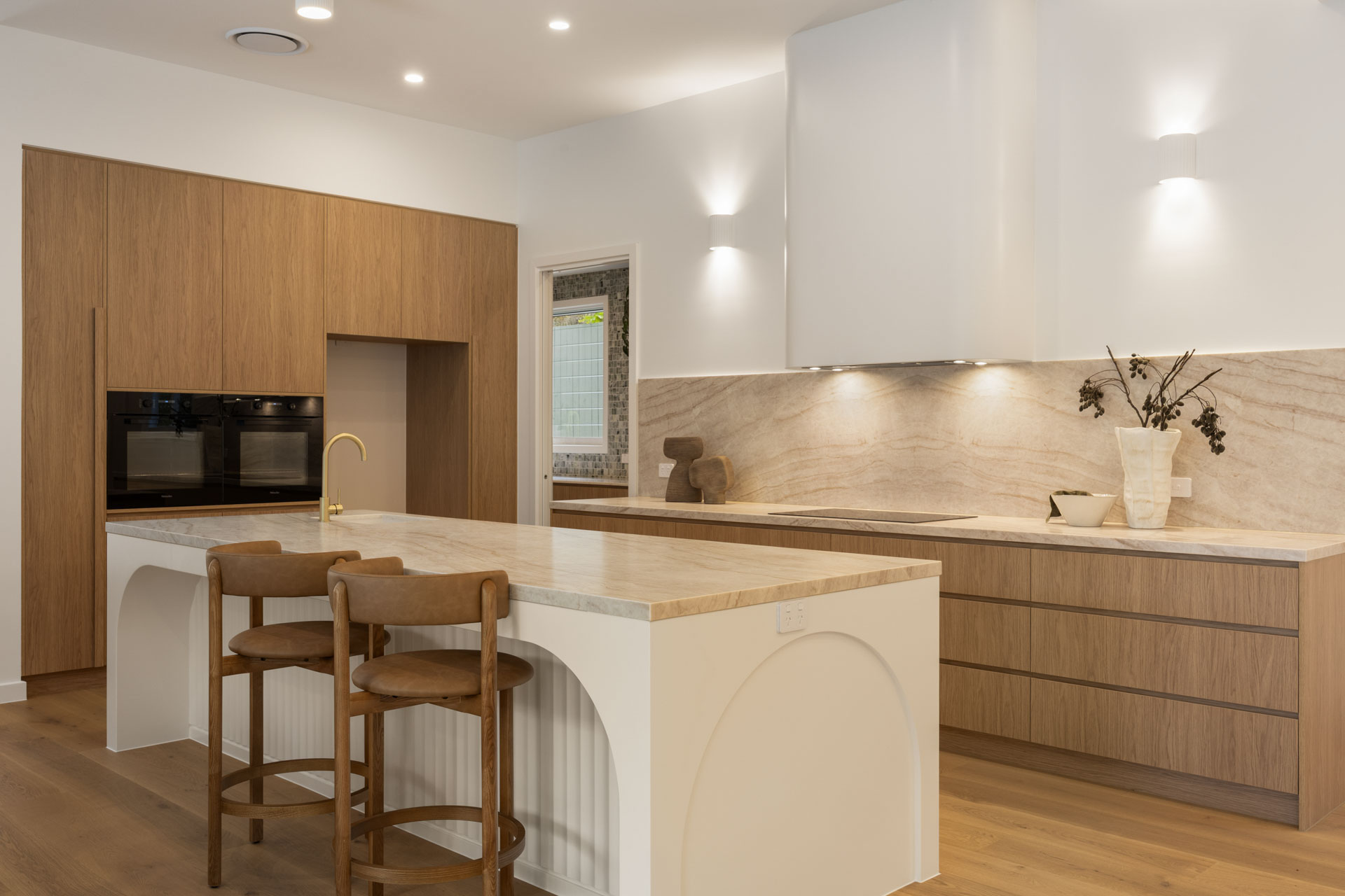 Kitchen with stone benchtops and oak cabinetry