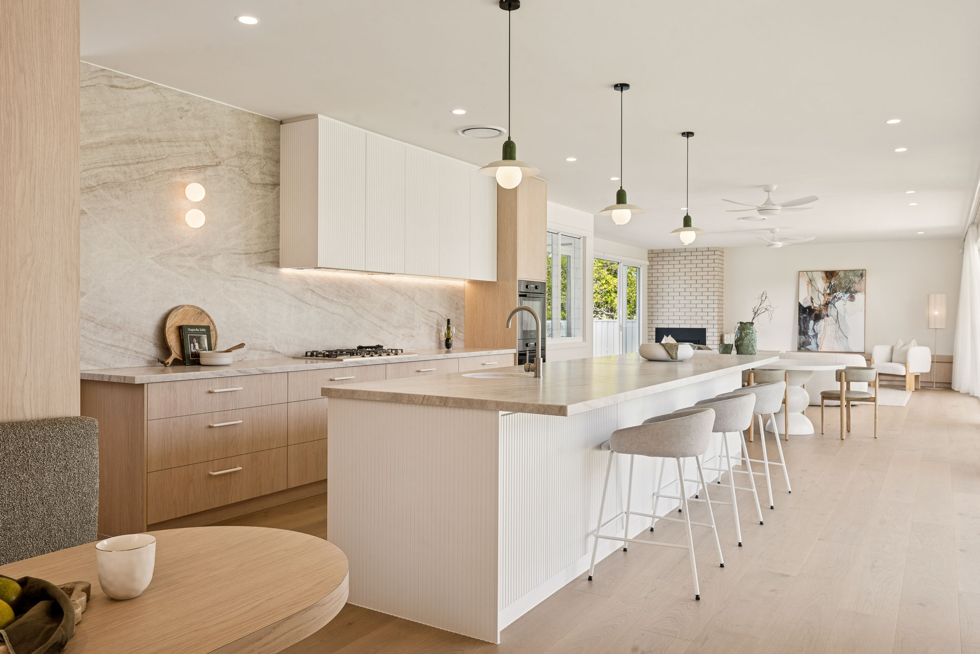 Kitchen with stone island bench and pendant lighting