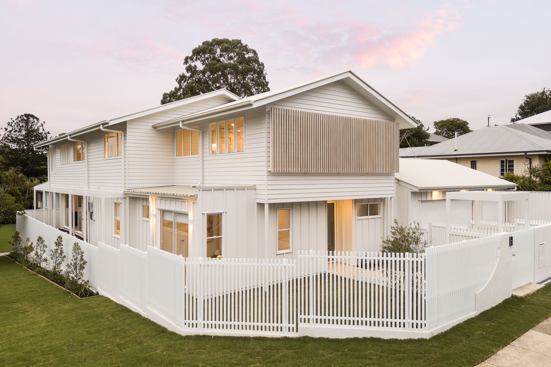 Front elevation from the street corner at dusk