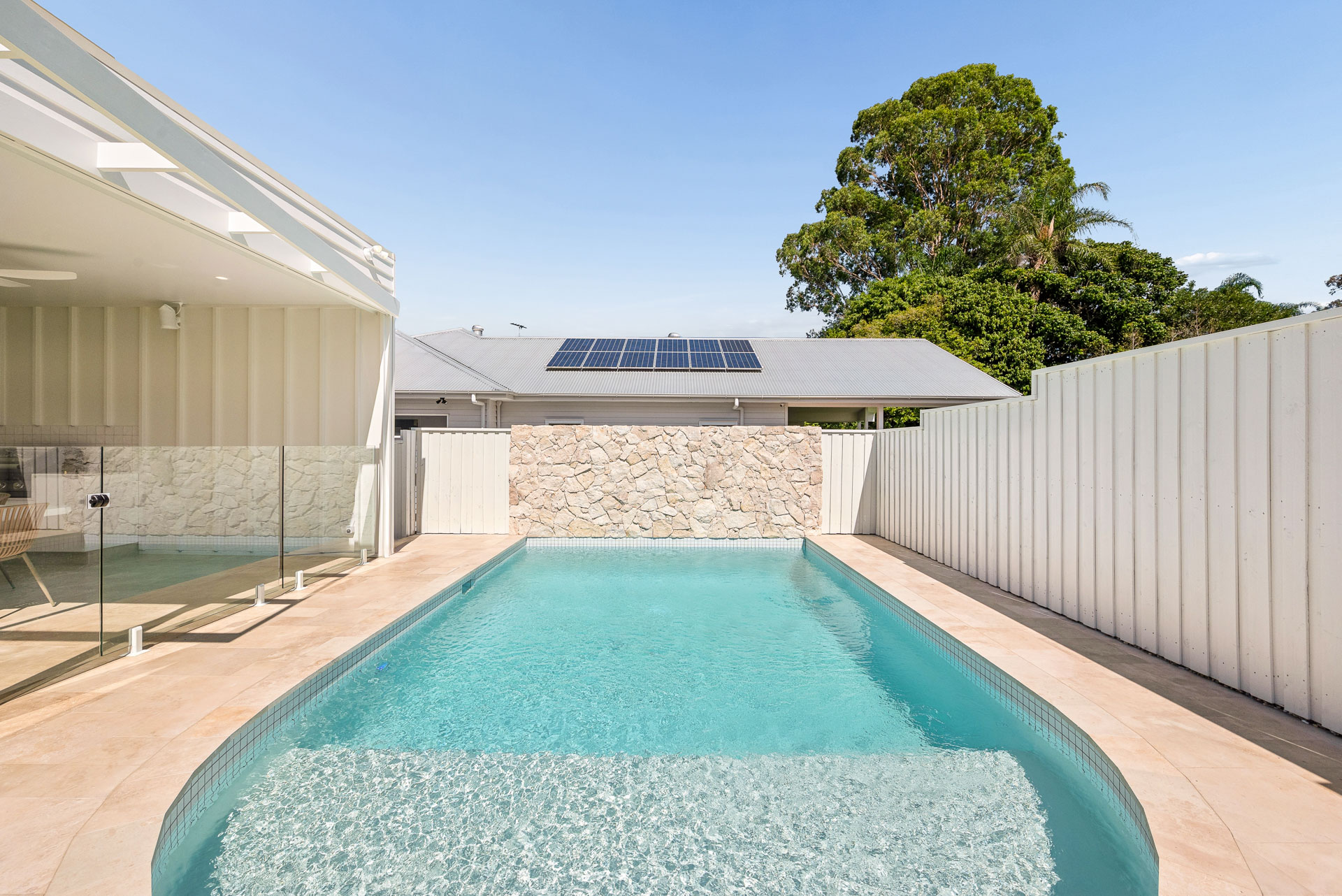 Rear elevation, lawn and pool