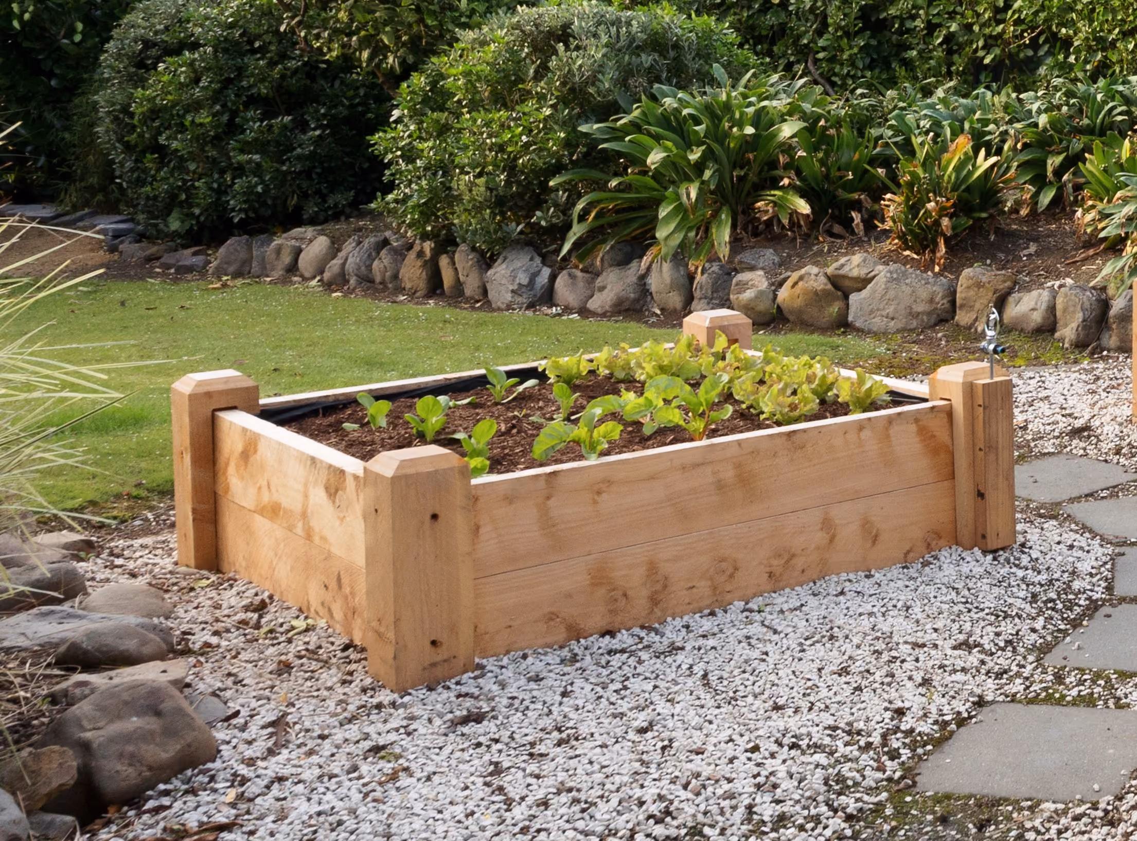 Macbox kitset planter in a garden