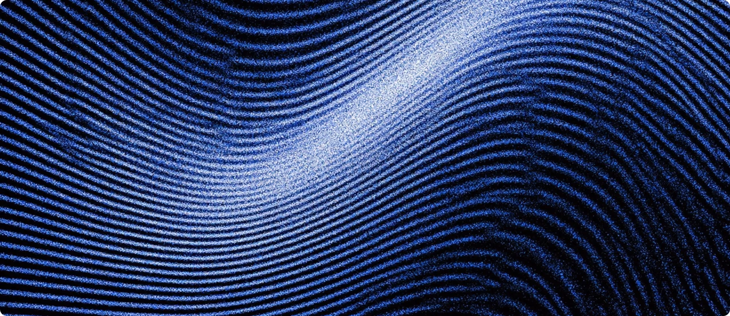 Close-up of swirling blue and black lines resembling a fingerprint pattern with a bright highlight area.