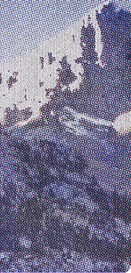 Close-up of a printed halftone image showing a person wearing a hat and a dark jacket, with visible dot pattern typical of print media.