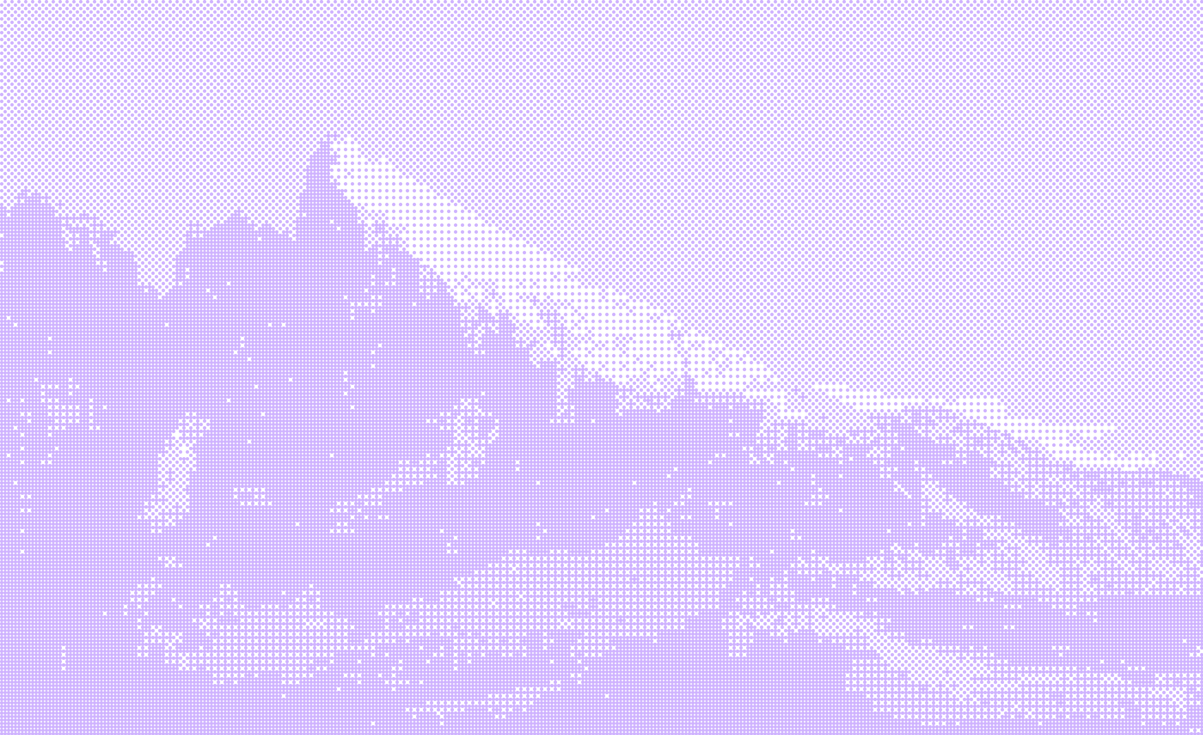 Snow-covered mountain peak rises above rugged rocky terrain under a clear sky.