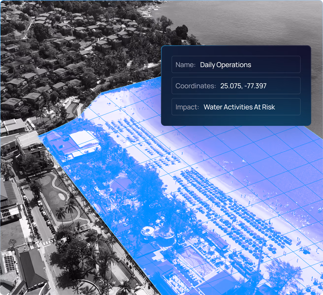 Aerial view of a coastal area with a beach and nearby buildings, overlaid with a blue grid highlighting a section of the beach and an information box showing Name: Daily Operations, Coordinates: 25.075, -77.397, Impact: Water Activities At Risk.
