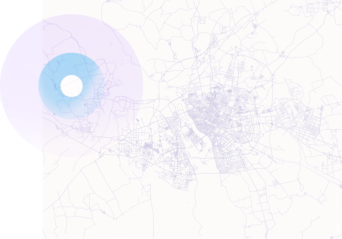 Map highlighting an urban area with light purple lines representing streets and roads, overlaid by translucent concentric circles in purple and blue on the left side, indicating a focused region or point of interest.