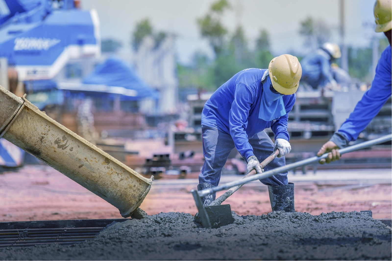 Worker levelling fresh concrete
