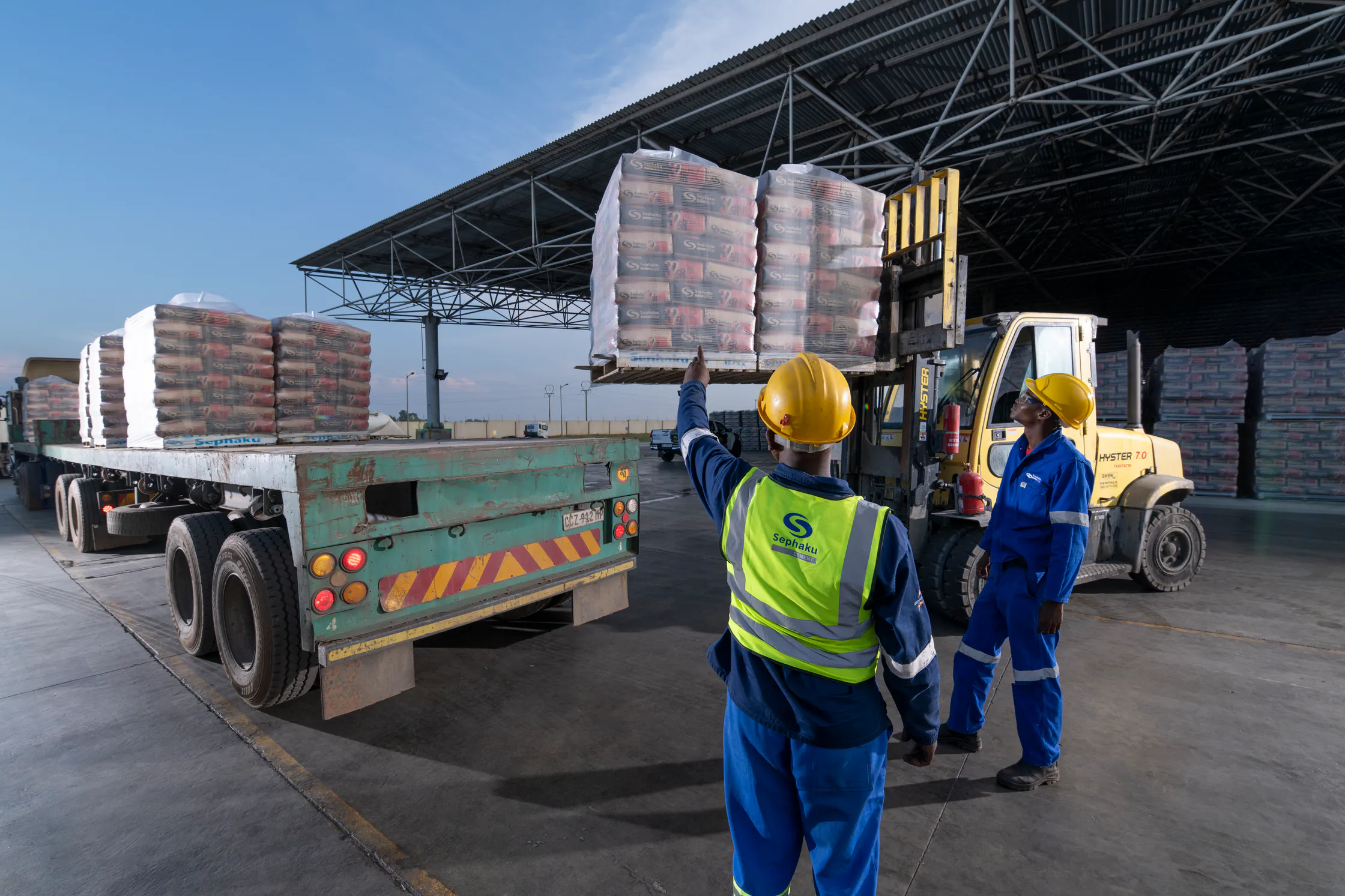 Workers loading pallets of Sephaku cement bags onto a truck at the Delmas plant