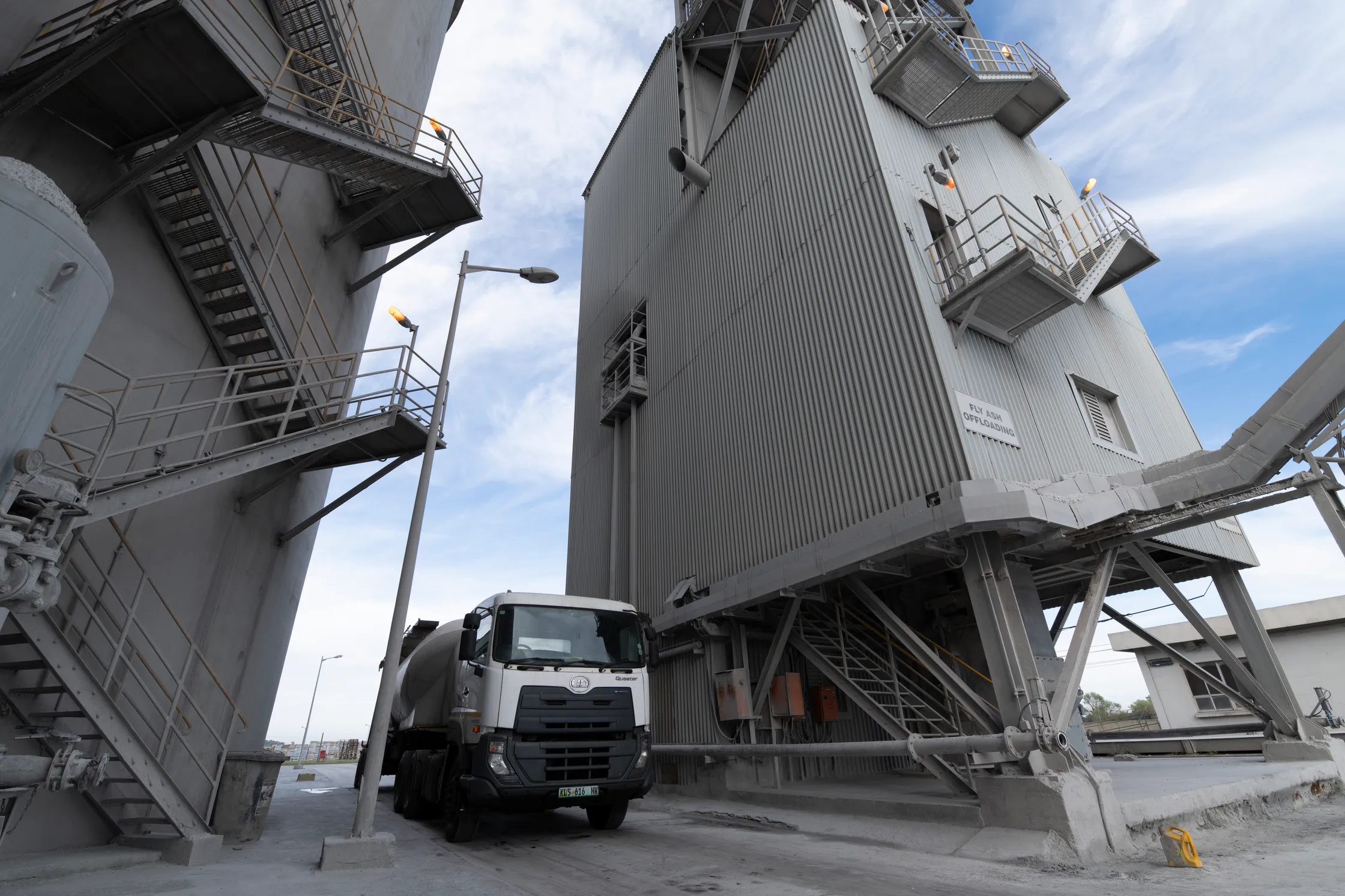 Bulk cement truck beneath the loading tower at the Delmas plant