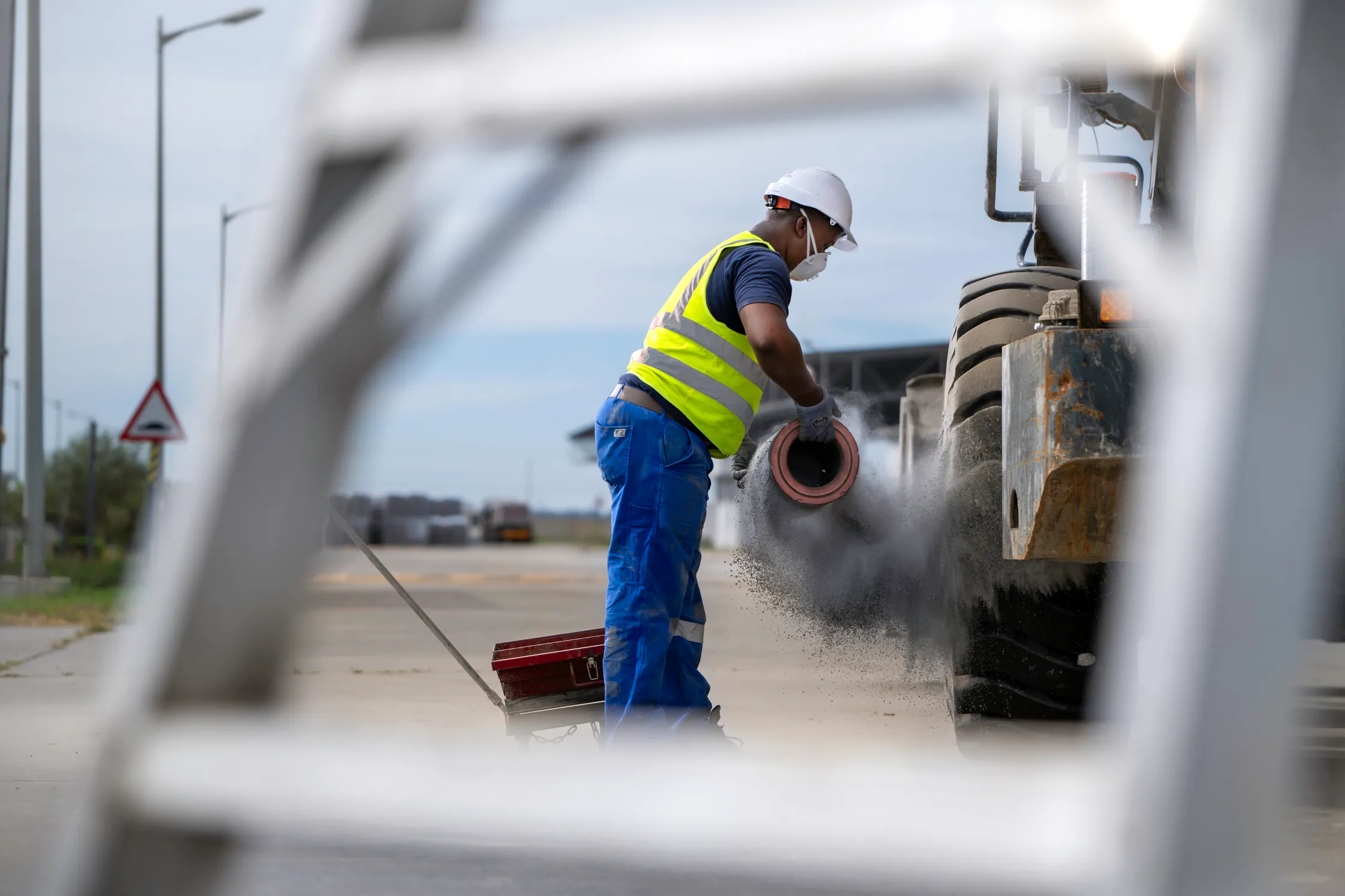 Worker cleaning equipment in the Delmas plant yard
