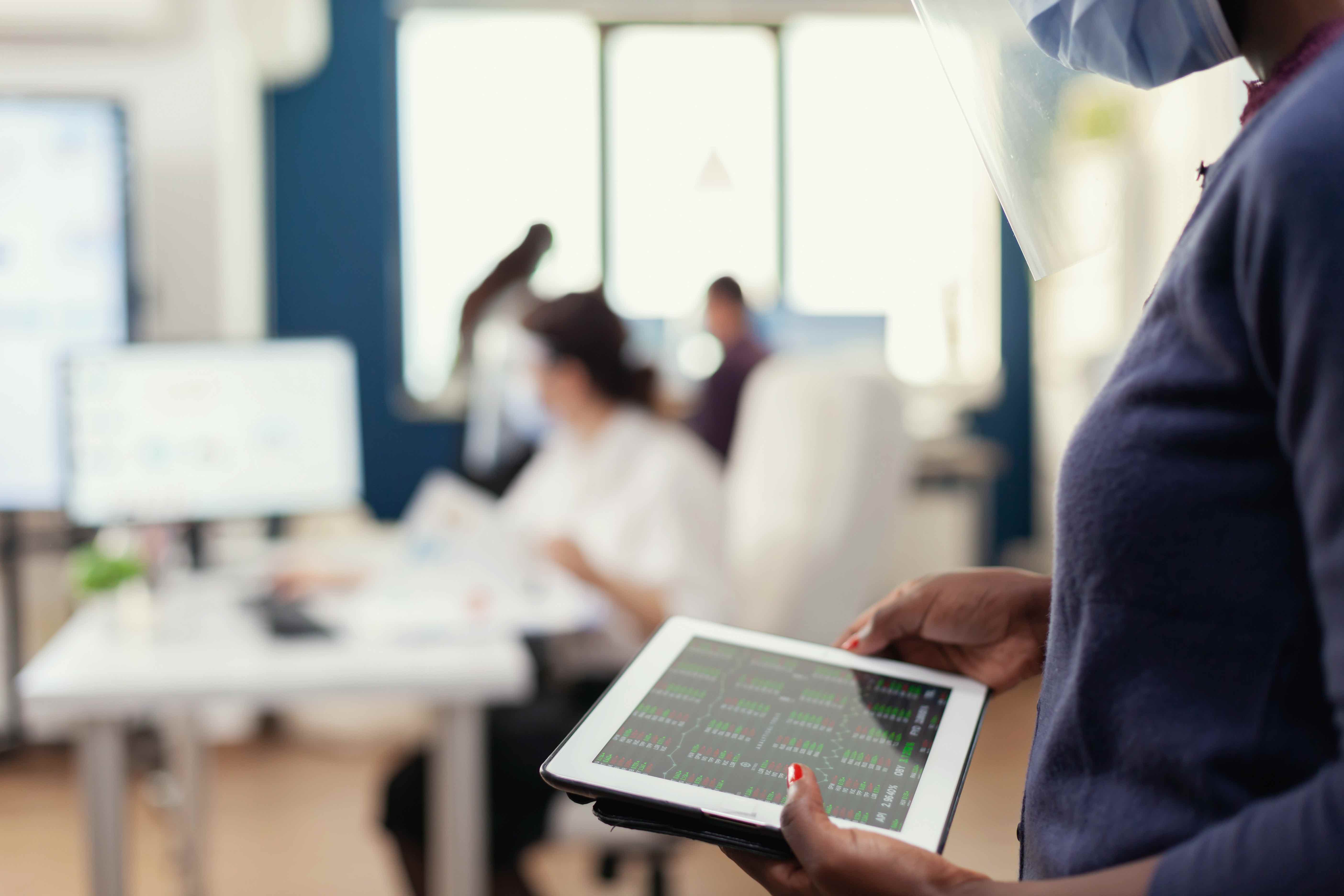 Professional reviewing health statistics on a tablet in a laboratory