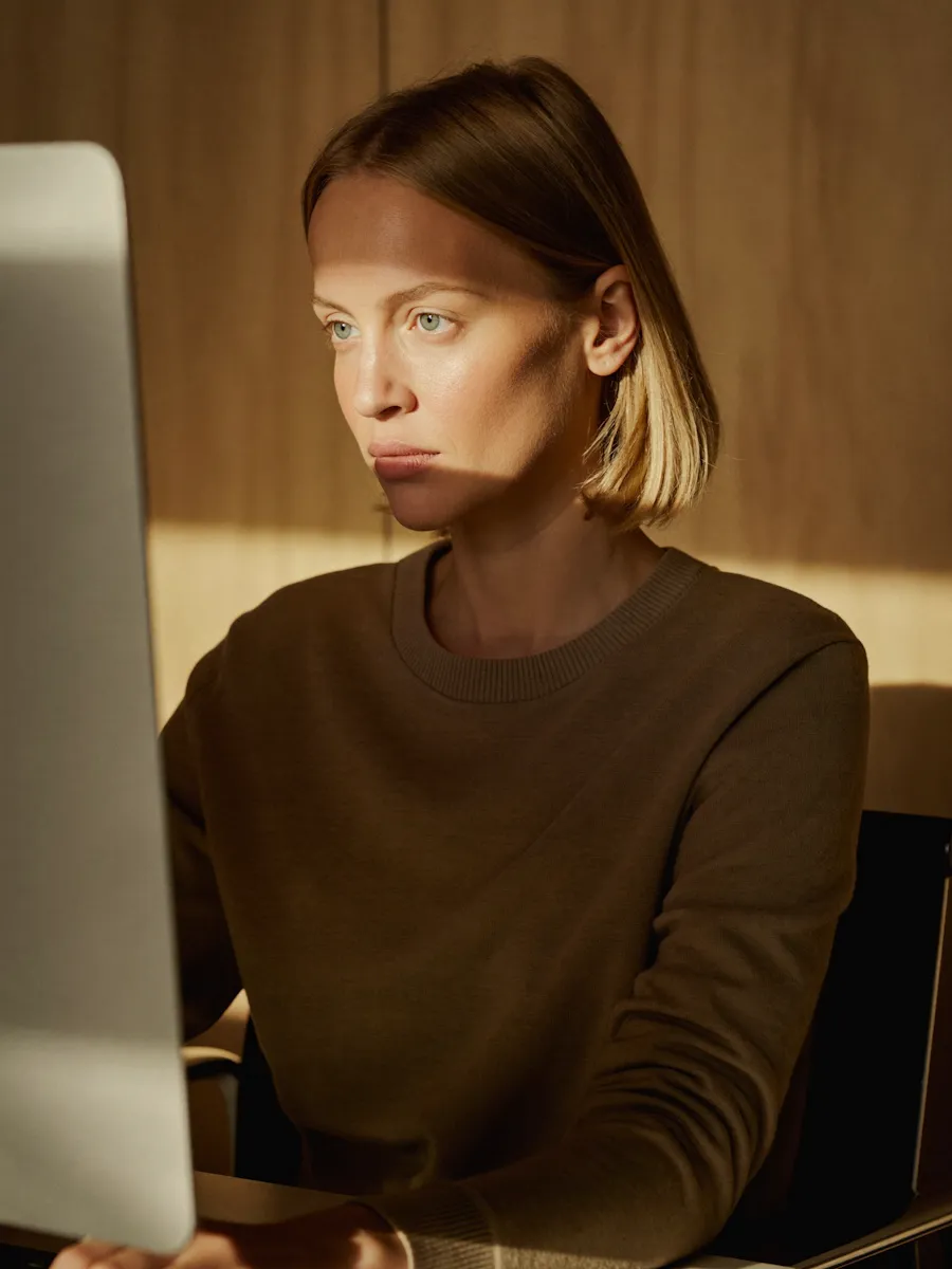 A woman sitting in front of a laptop computer.