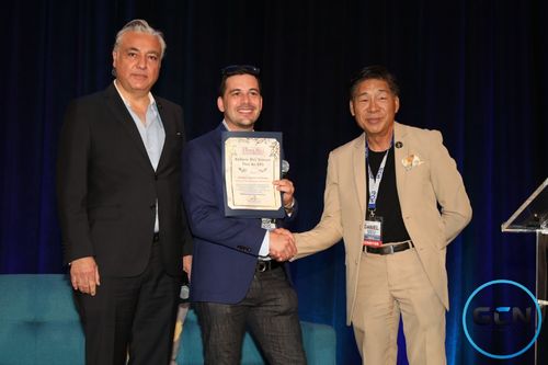 Josh Bois receiving the California State Treasurer certificate on stage at the GCN Investor Conference
