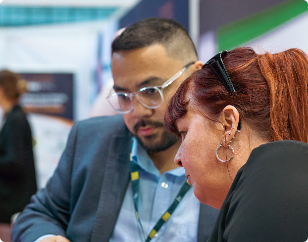 DACI engineer in discussion with a visitor at an industry event.