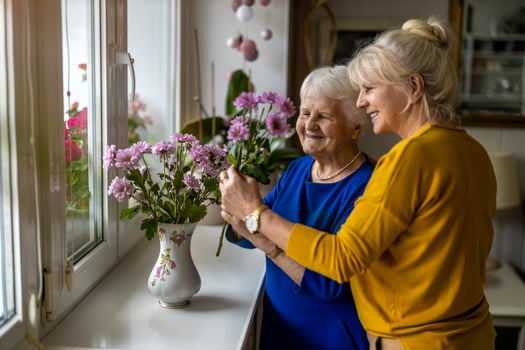 Daughter helping elderly mother with Alzheimer's