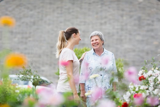 Older MS patient talking with caregiver