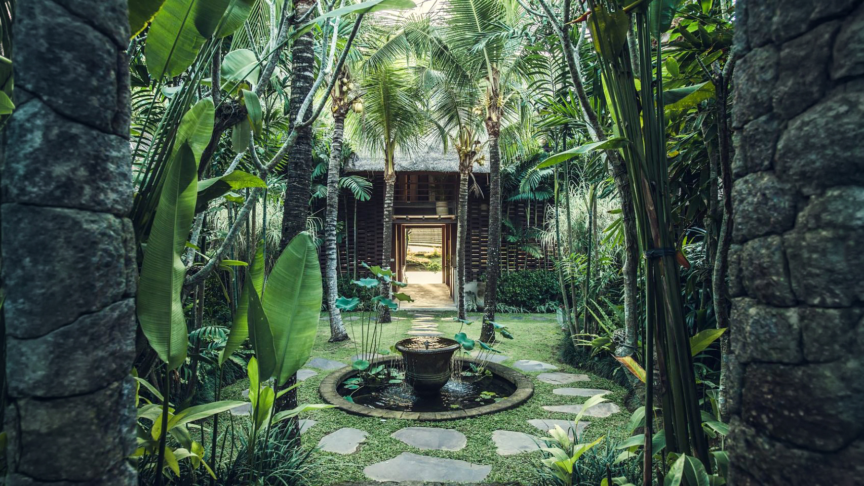 Palm-lined garden path leading to the villa entrance