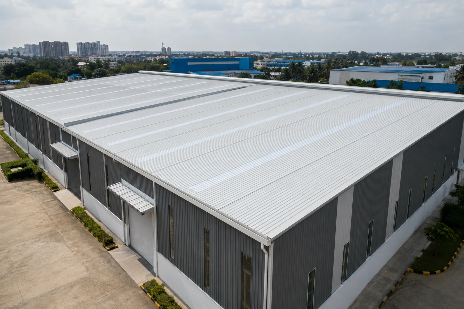Completed insulated roof and wall panel system on an industrial building